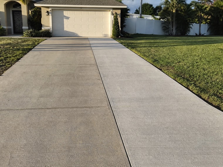 An Orlando driveway widened by a strip of new concrete poured alongside the original slab