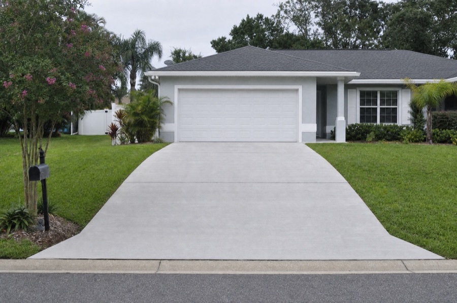 The same driveway after the failed section was cut out and repoured, the surface level and uniform