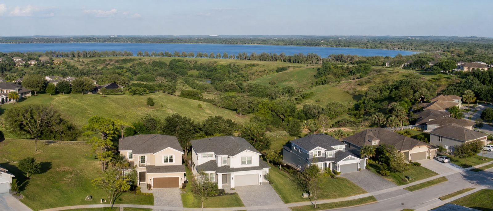 A low aerial view of Clermont, Florida, with residential driveways in the foreground