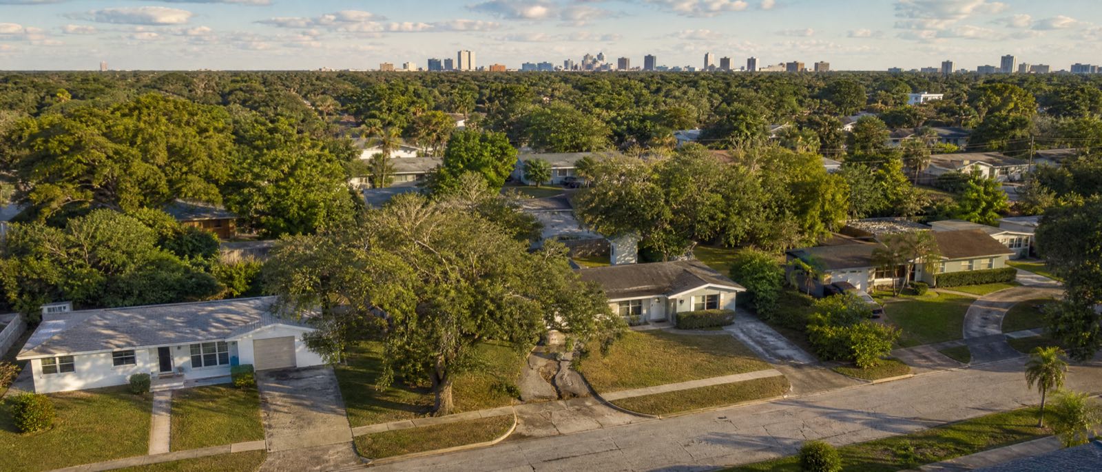 A low aerial view of Orlando, Florida, with residential driveways in the foreground