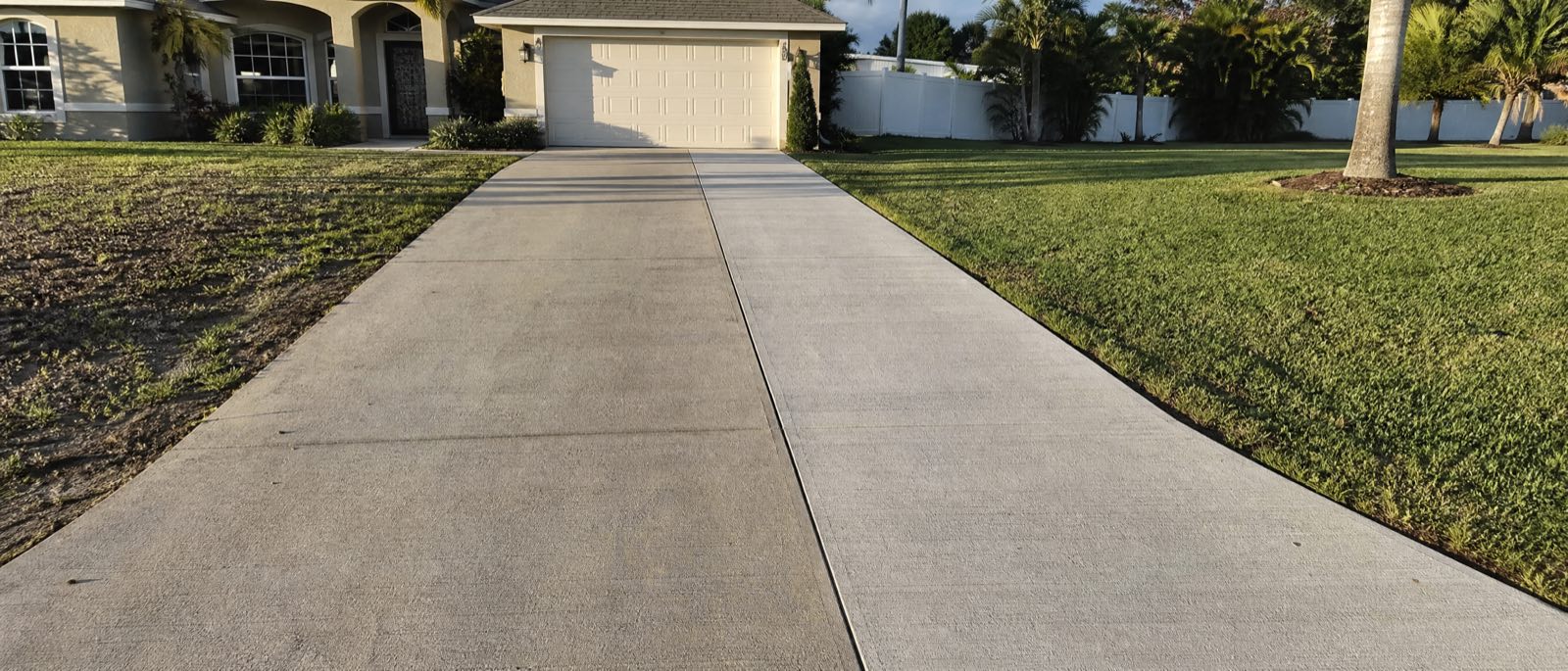 An Orlando driveway widened by a new strip of concrete poured alongside the original, the two slabs matched in finish